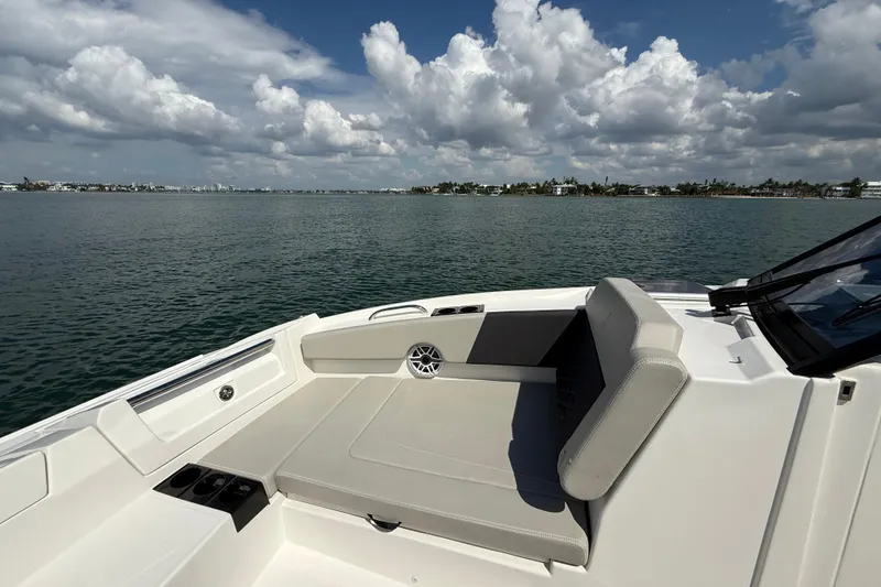 Slide: The Image of Aquila 32 Sport 2025 boat interior with seating, overlooking calm waters and cloudy sky. - 40