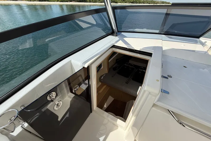 Slide: The Image of 2025 Aquila 32 Sport boat interior with open hatch, sleek design, and waterfront view. - 45