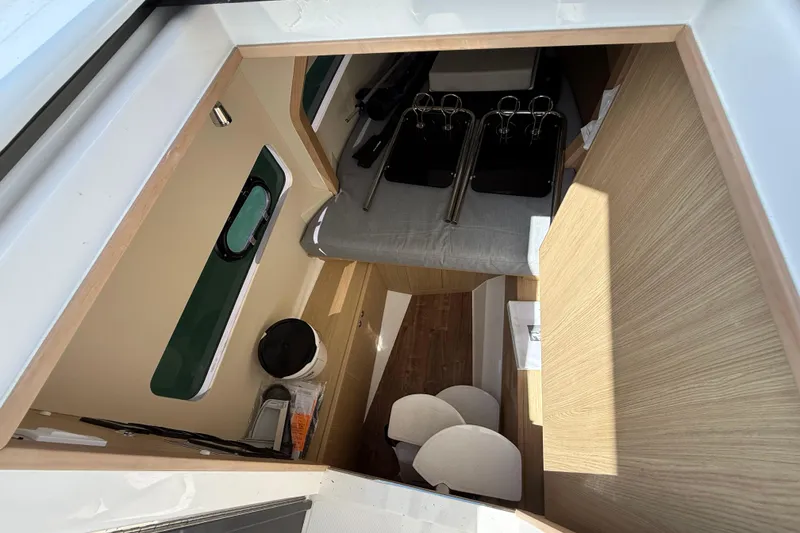 Slide: The Image of Interior view of 2025 Aquila 32 Sport boat, featuring modern design and wood accents. - 46