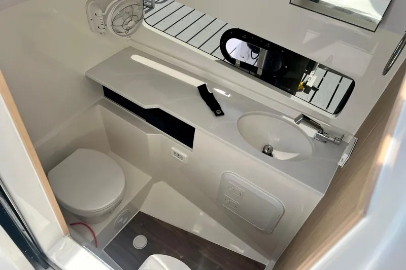 Slide: The Image of Modern bathroom interior of 2025 Aquila 32 Sport boat, featuring toilet and sink. - 48