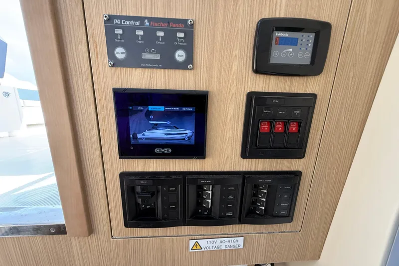 Slide: The Image of Control panel of 2025 Aquila 32 Sport boat with various switches and displays. - 50