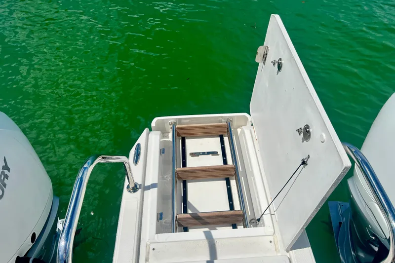 Slide: The Image of Aquila 32 Sport 2025 boat with open swim platform ladder on green water. - 53