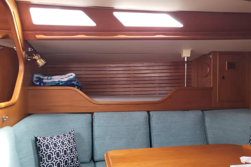 Slide: The Image of Close-up of 1985 Swan 46 yacht deck with polished metal fittings and wooden planks. - 10