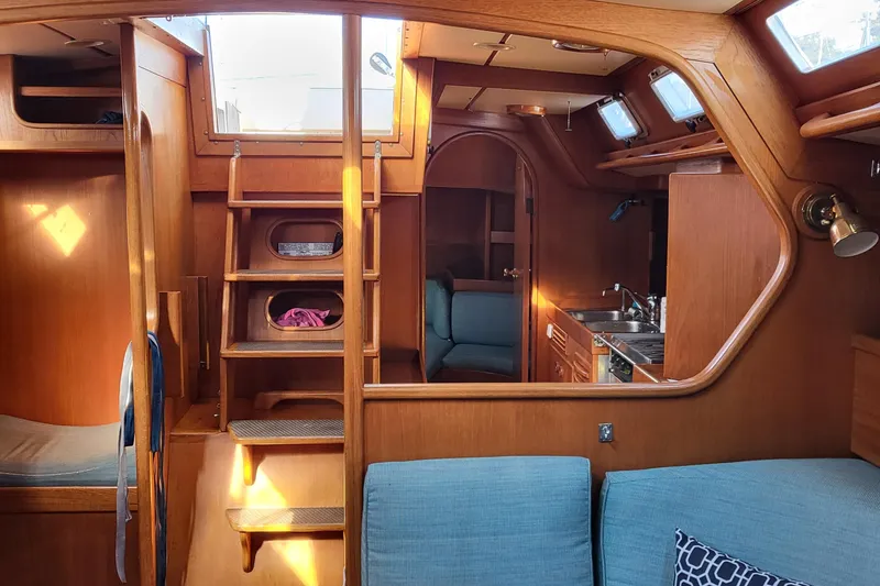 Slide: The Image of Deck of 1985 Swan 46 sailboat with wooden finish and nautical ropes. - 11