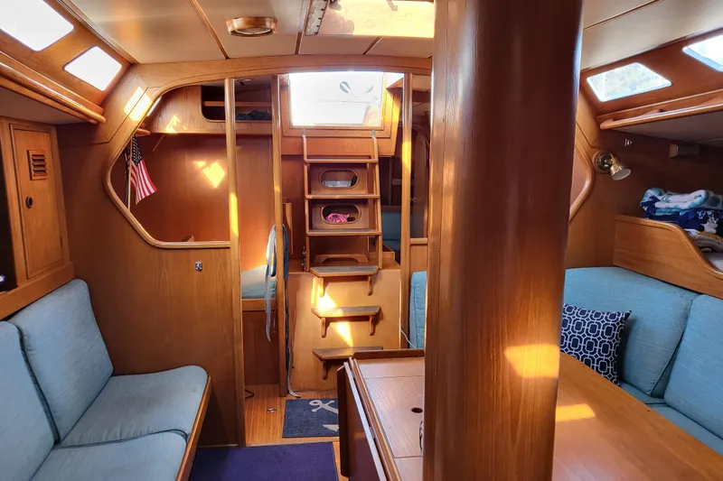 Slide: The Image of 1985 Nautor Swan 46 sailboat docked, showcasing deck and rigging under clear blue sky. - 12