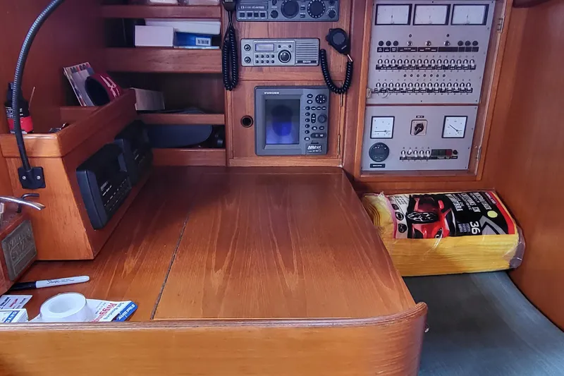 Slide: The Image of Interior of 1985 Swan 46 yacht with wooden furnishings and blue seating. - 17
