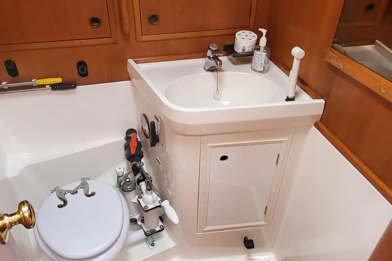 Slide: The Image of Interior of 1985 Swan 46 yacht with wooden finish and blue seating. - 23