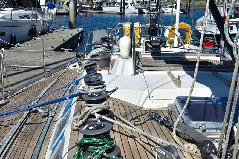 Slide: The Image of 1985 Swan 46 yacht bathroom with wooden cabinets, sink, and blue towel. - 27