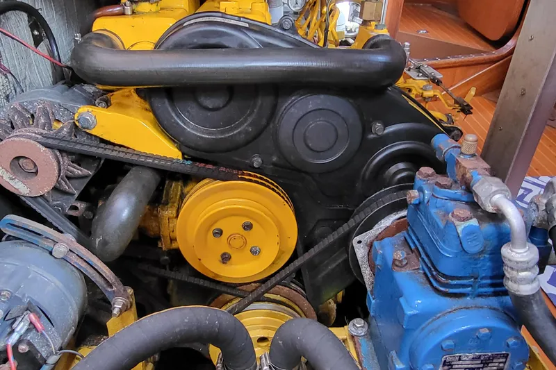 Slide: The Image of Engine compartment of a 1985 Swan 46 yacht, featuring yellow components and wiring. - 35