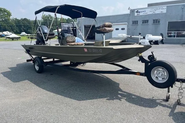 Slide: The Image of 2020 Tracker Grizzly 1860 CC boat on trailer, parked outdoors near a building. - 3