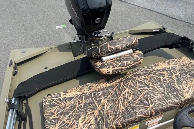 Slide: The Image of 2020 Tracker Grizzly 1860 CC boat with camouflage seating and motor, ideal for outdoor adventures. - 5