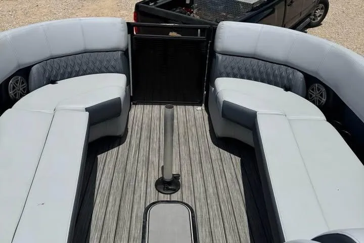 Slide: The Image of 2020 Harris Solstice 250 boat interior with gray seating and striped flooring. - 17