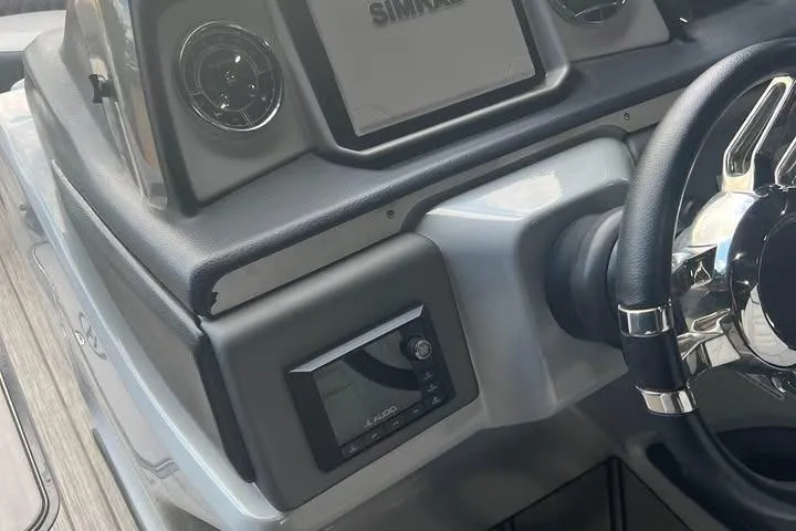 Slide: The Image of 2020 Harris Solstice 250 boat dashboard with steering wheel and electronic display. - 18