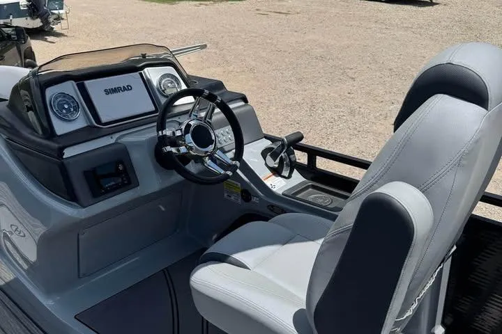 Slide: The Image of 2020 Harris Solstice 250 boat cockpit with steering wheel and control panel. - 19