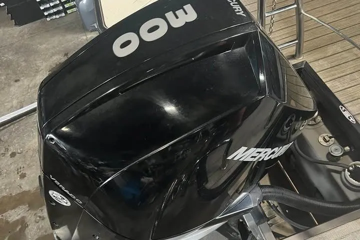 Slide: The Image of 2020 Harris Solstice 250 with powerful Mercury 300 outboard engine in a garage setting. - 7