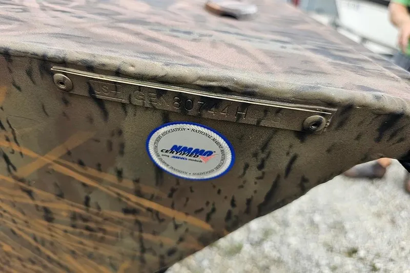 Slide: The Image of 2023 G3 Sportsman 1810 Camo boat with identification plate and certification sticker. - 19