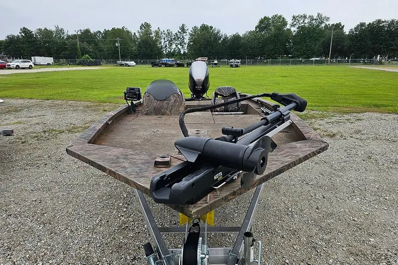 Slide: The Image of 2023 G3 Sportsman 1810 Camo boat on trailer, featuring camouflage design and motor. - 3