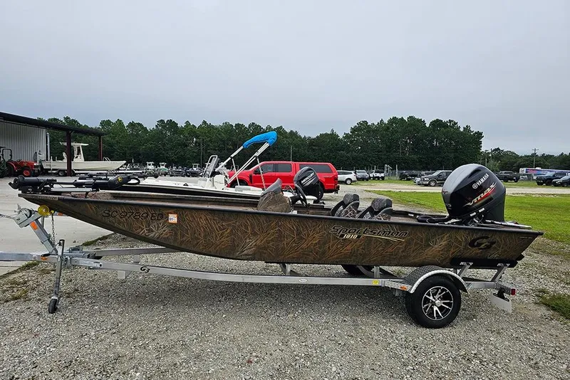 Slide: The Image of 2023 G3 Sportsman 1810 Camo boat on trailer, parked outdoors. - 5