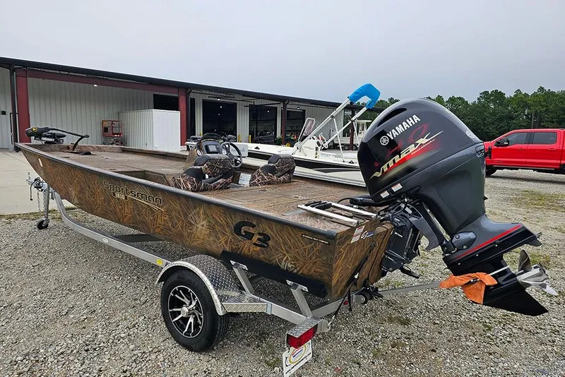 Slide: The Image of 2023 G3 Sportsman 1810 Camo boat with Yamaha motor on trailer, parked outdoors. - 6