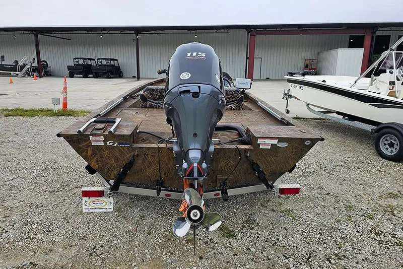 Slide: The Image of 2023 G3 Sportsman 1810 Camo boat with outboard motor, parked on gravel. - 7