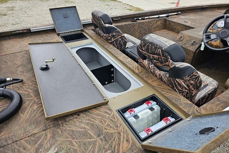 Slide: The Image of 2023 G3 Sportsman 1810 Camo boat interior with camo seats and storage compartments. - 9