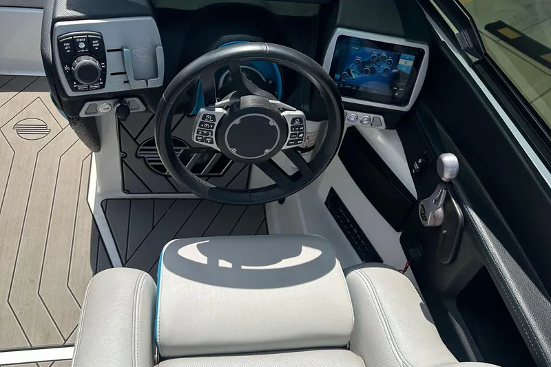 Slide: The Image of 2018 Malibu Wakesetter 23 LSV dashboard with steering wheel and touchscreen display. - 15