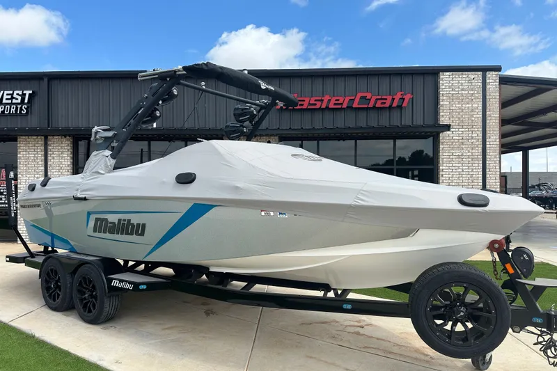 Slide: The Image of 2018 Malibu Wakesetter 23 LSV boat covered on trailer, parked outside dealership. - 18