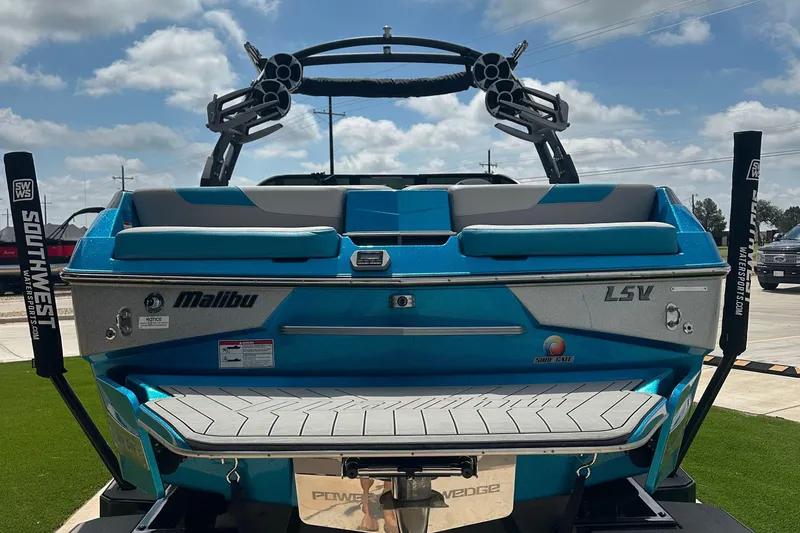 Slide: The Image of 2018 Malibu Wakesetter 23 LSV boat, rear view, blue and silver, parked outdoors. - 4