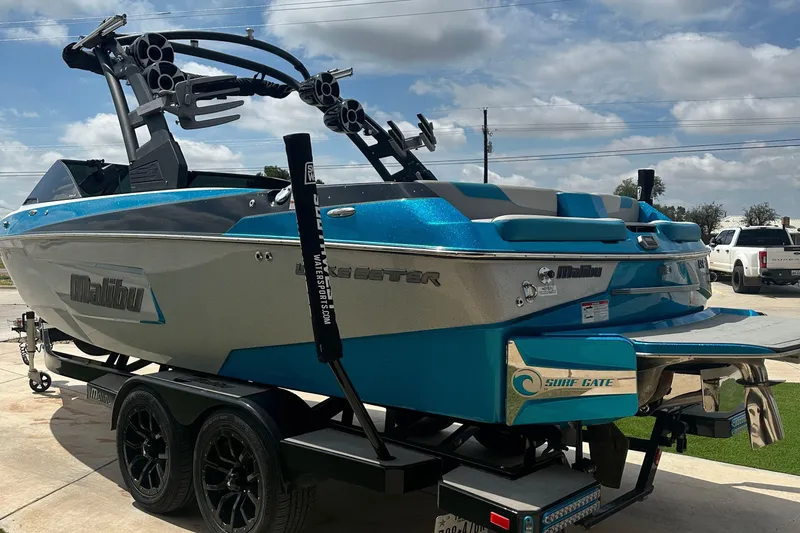 Slide: The Image of 2018 Malibu Wakesetter 23 LSV boat on trailer, featuring sleek design and vibrant blue accents. - 5