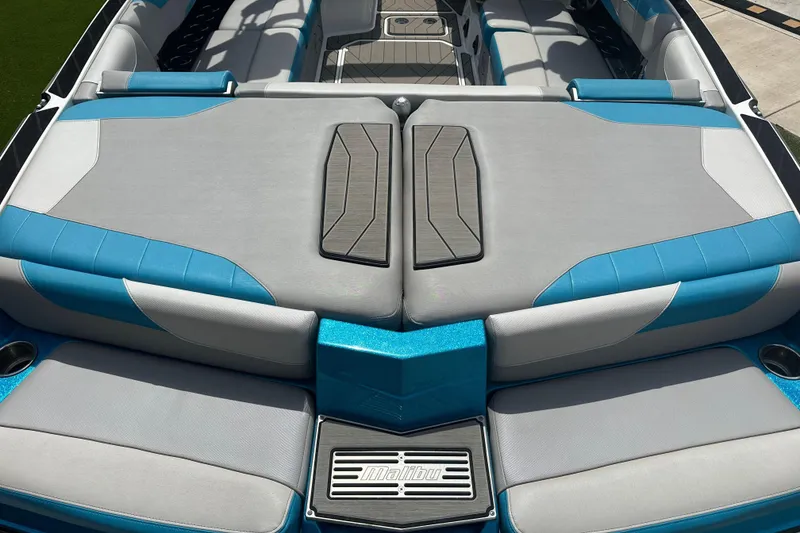 Slide: The Image of 2018 Malibu Wakesetter 23 LSV boat interior with blue and gray seating. - 8