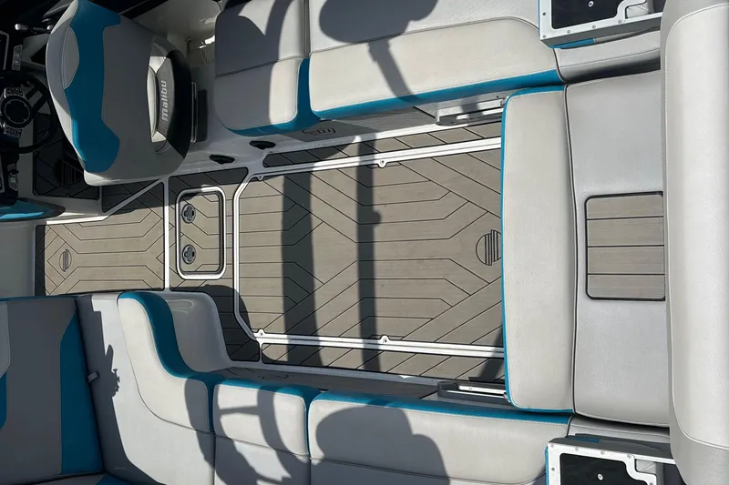 Slide: The Image of 2018 Malibu Wakesetter 23 LSV interior with gray and blue seating and sleek flooring design. - 9