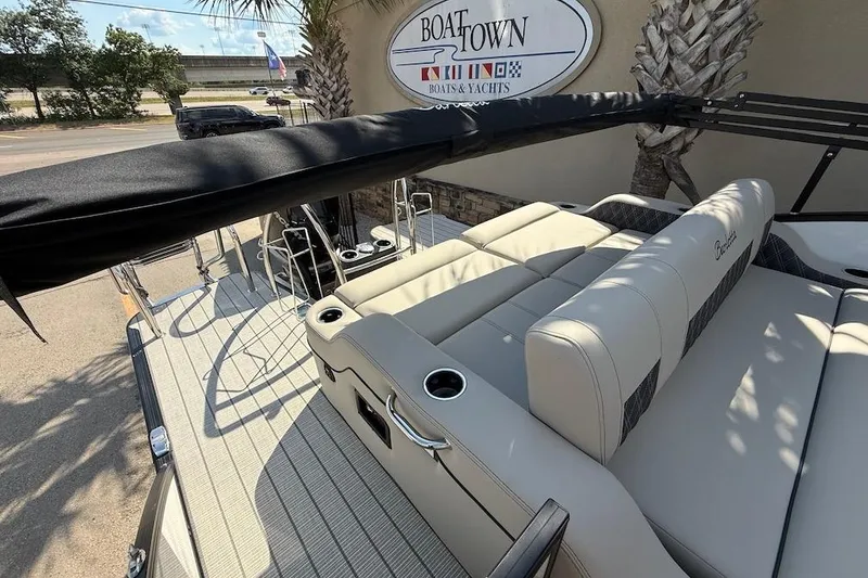 Slide: The Image of 2021 Barletta L23UC pontoon boat with beige seating at Boat Town dealership. - 11