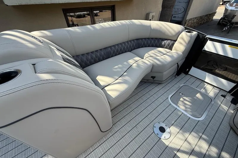 Slide: The Image of Luxurious seating on 2021 Barletta L23UC pontoon boat, featuring elegant upholstery and cup holders. - 14