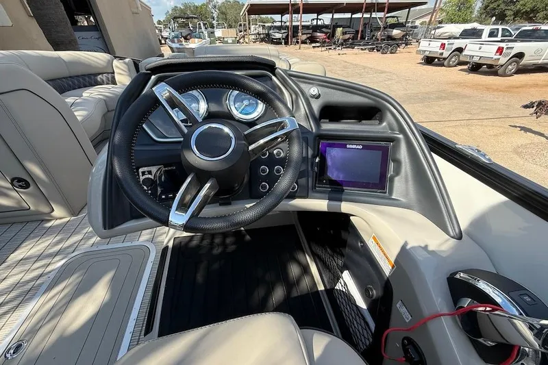 Slide: The Image of 2021 Barletta L23UC boat dashboard with steering wheel and Simrad display. - 9