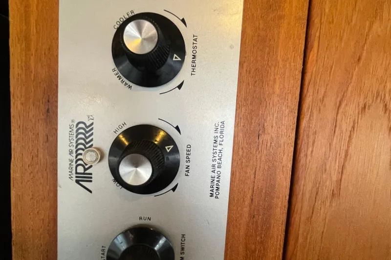 Slide: The Image of Control panel of 1989 Bayliner Pilothouse 4588, featuring thermostat and fan speed dials. - 13