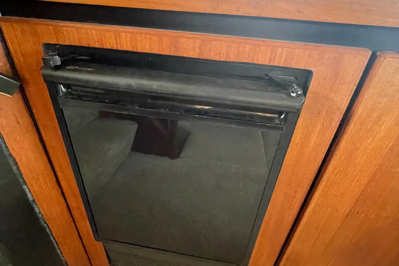 Slide: The Image of 1989 Bayliner Pilothouse 4588 interior with wooden cabinetry and built-in appliance. - 14