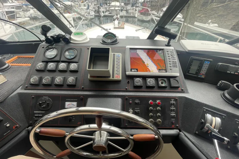 Slide: The Image of 1989 Bayliner Pilothouse 4588 helm with navigation instruments and steering wheel. - 18