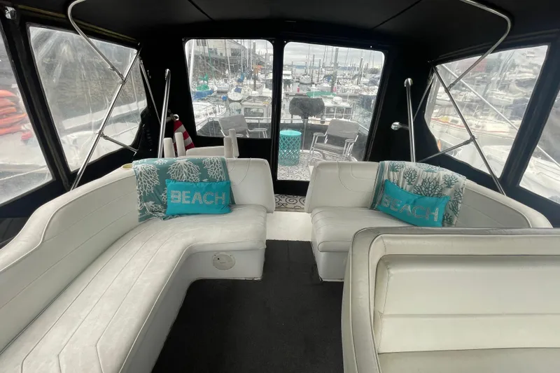 Slide: The Image of Interior of 1989 Bayliner Pilothouse 4588 with white seating and decorative pillows. - 27