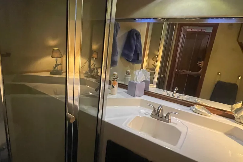 Slide: The Image of Bathroom interior of 1989 Bayliner Pilothouse 4588 with sink and mirror. - 35