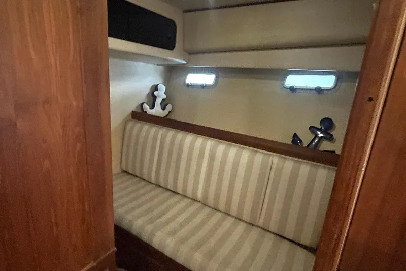 Slide: The Image of 1989 Bayliner Pilothouse 4588 interior with striped seating and nautical decor. - 39
