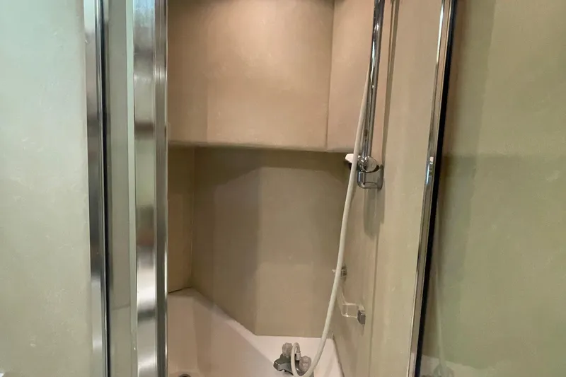 Slide: The Image of Shower area inside 1989 Bayliner Pilothouse 4588 yacht, featuring modern fixtures and beige walls. - 41