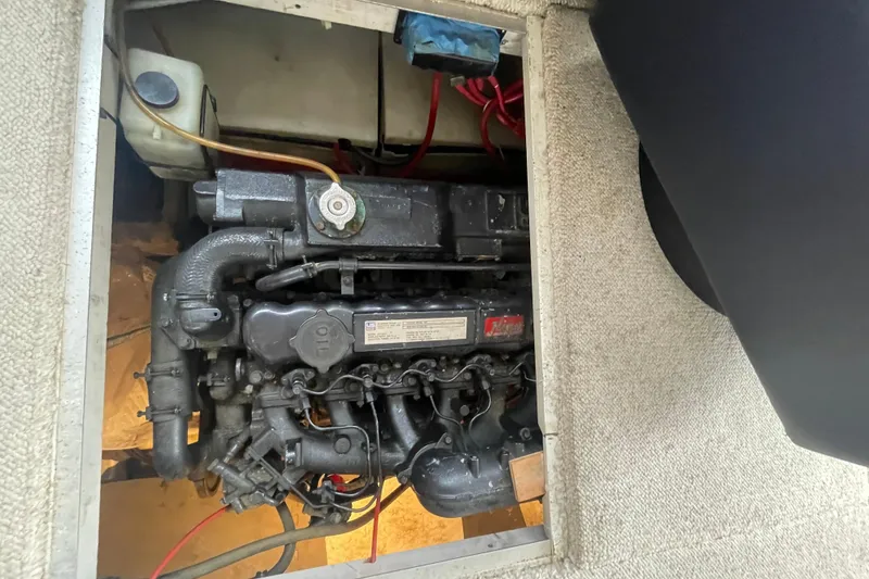Slide: The Image of Engine compartment of 1989 Bayliner Pilothouse 4588, showcasing mechanical components and wiring. - 43