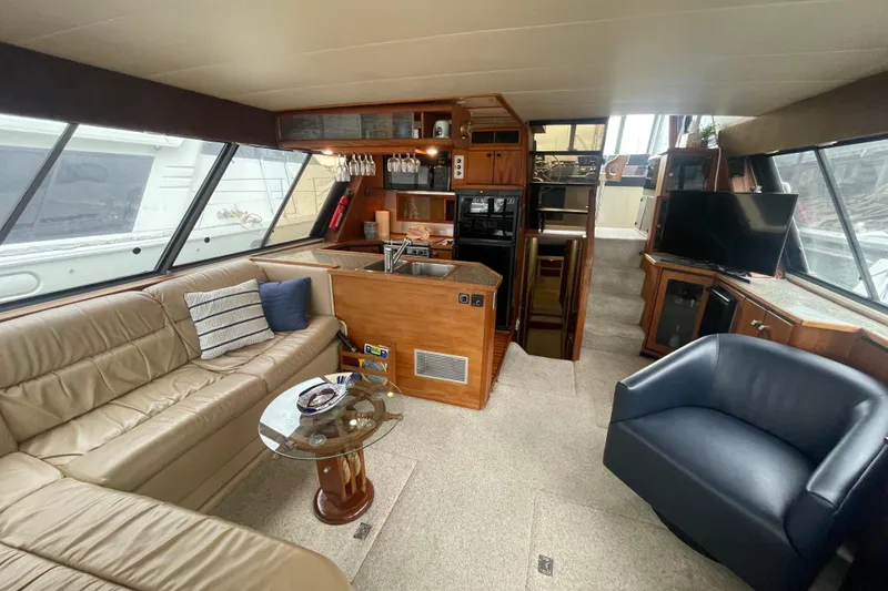 Slide: The Image of Luxurious interior of 1989 Bayliner Pilothouse 4588 yacht with modern amenities and seating. - 5