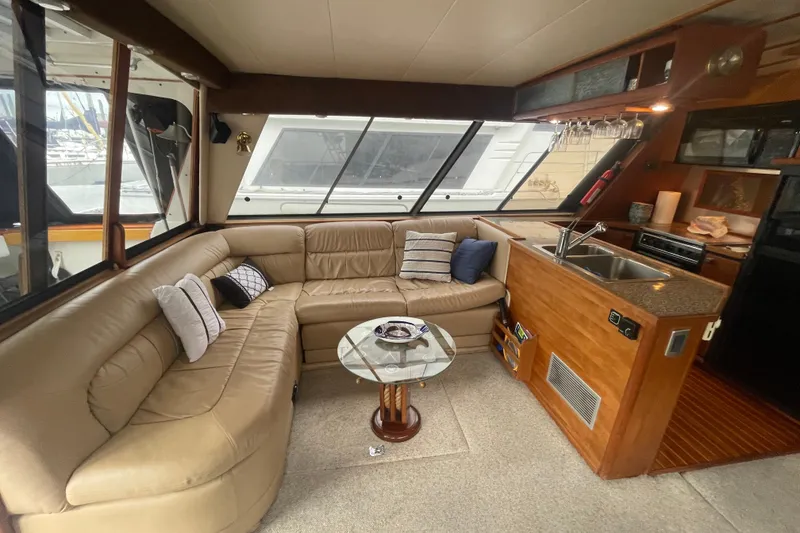 Slide: The Image of Interior of 1989 Bayliner Pilothouse 4588 with leather seating and kitchenette. - 6