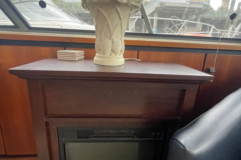 Slide: The Image of 1989 Bayliner Pilothouse 4588 interior with wooden cabinet and decorative vase. - 8