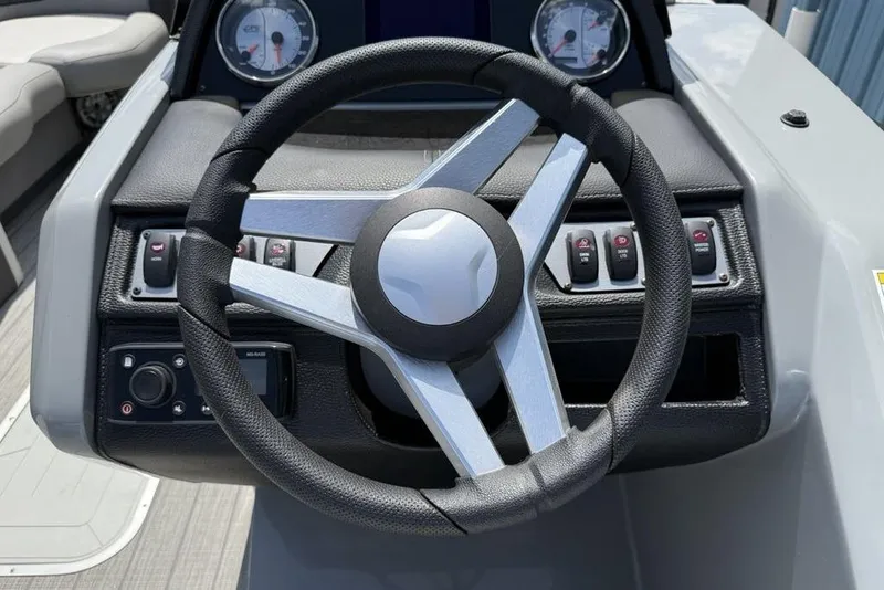 Slide: The Image of Steering wheel of 2021 Godfrey Monaco 235 SFL GTP boat, featuring control panel and gauges. - 10
