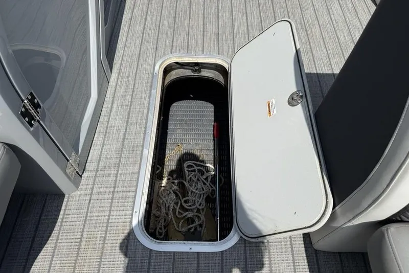 Slide: The Image of Open storage compartment on 2021 Godfrey Monaco 235 SFL GTP boat, showing ropes inside. - 14