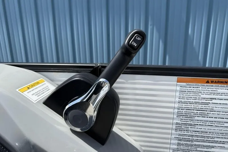 Slide: The Image of Control lever on a 2021 Godfrey Monaco 235 SFL GTP boat, with caution and warning labels. - 19