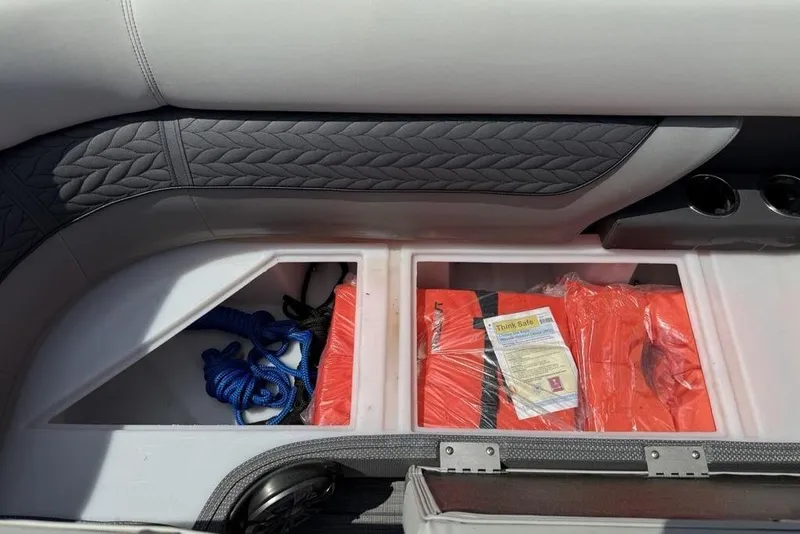 Slide: The Image of Storage compartment in a 2021 Godfrey Monaco 235 SFL GTP boat with life jackets and rope. - 9