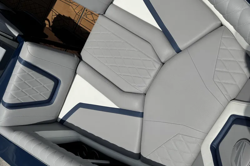 Slide: The Image of 2021 Tigé 23ZX boat interior with gray and blue diamond-stitched upholstery. - 7